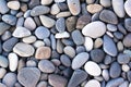 Background with round pebble stones. Stones beach smooth, flat lay texture in daylight. Top view. Summer day Royalty Free Stock Photo