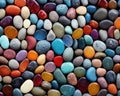 The background is round pebbles with multicolored rounded shiny small stones. Royalty Free Stock Photo