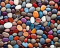 The background is round pebbles with multicolored rounded shiny small stones. Royalty Free Stock Photo