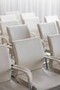 Background of row of white seats. Empty hairs in the conference hall