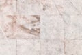 Background with rows of even beige tiles. Texture of old marble close-up. Royalty Free Stock Photo