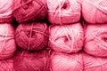 background of rows skeins of fluffy wool yarn for knitting soft red pink purple hue colors. toned in viva magenta Royalty Free Stock Photo