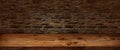 Rustic wooden table with stone wall Royalty Free Stock Photo