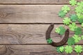 Background with rusty horseshoe and paper clover leaves on the o Royalty Free Stock Photo