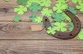 Background with rusty horseshoe and paper clover leaves on the o Royalty Free Stock Photo
