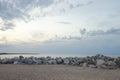 Background from the sandy shore of the lake with stones Royalty Free Stock Photo