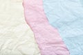 Background of scraps of white, pink and blue crumpled paper