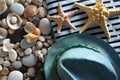 Background with sea stones, seashells, hat and beach towel