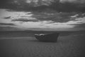 Fishermens boat at seacoast, on sand at sunset with horisont sea on background. Travel and rest concept. Background of Royalty Free Stock Photo