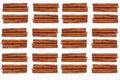 Background with a set of cinnamon sticks brown, lie in rows of four on a white isolated ground, a popular aromatic spice used in Royalty Free Stock Photo