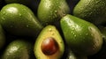 Background of several fresh green avocados and one half an avocado with water droplets on them on a black background Royalty Free Stock Photo