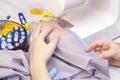 Background sewing. Hands of a seamstress on a sewing machine.