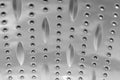 Background sheet of metal covered with lines of circular holes Royalty Free Stock Photo