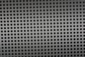 Background sheet of metal covered with lines of circular holes. Royalty Free Stock Photo
