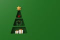 Background shelf christmas tree shape with gift box and decorate element on luxury green background