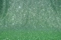 A background of shimmering green sequins cascading over a subtle emerald gradient, creating a festive and radiant texture Royalty Free Stock Photo