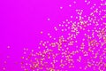 Background of shiny golden small stars on a fuchsia background. Selective focus. Christmas concept. Glitter texture Royalty Free Stock Photo