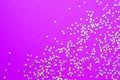 Background of shiny little stars on a bright pink background. Selective focus. Christmas concept. Glitter texture