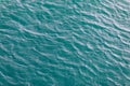 Background shot of aqua sea water surface. Sea surface aerial view. Waving water surface of the sea background