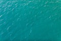 Background shot of aqua sea water surface. Sea surface aerial view. Waving water surface of the sea background