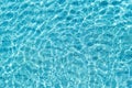 Background shot of aqua water surface. Swimming pool with sunny reflections. Royalty Free Stock Photo