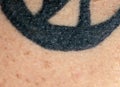 Background with human skin texture with stuffed dark blue and black tattoo letters