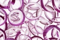 Background of sliced red onion rings, close up. Royalty Free Stock Photo