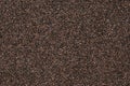 Background of small black pebbles. Modern paper design. Abstract grains pattern. Brown mottled texture of wall. Stone motley surfa