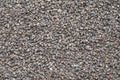 Background of small brown and gray pebbles. Rough stone wall, abstract pattern. Surface, rock texture. Royalty Free Stock Photo