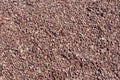 Background of small red pebbles. Walking path cover texture. Fine gravel