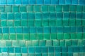 Background of small square tiles in different shades of blue and green