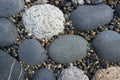 Background of smooth flat pebbles and gravel. Pebbles of different shapes and colors.