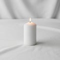 The background is softly blurred, emphasizing the candle\'s simplicity and Royalty Free Stock Photo