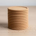 The background is softly blurred, emphasizing the focus on the stack of coasters Royalty Free Stock Photo