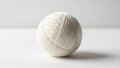 The background is a solid neutral color enhancing the focus on the yarn ball Royalty Free Stock Photo