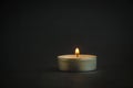 Background of sorrows lonely candle on a dark black texture