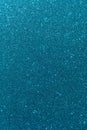 Background with sparkles. Backdrop with glitter. Shiny textured surface. Vertical image. Dark cyan