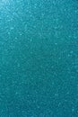 Background with sparkles. Backdrop with glitter. Shiny textured surface. Vertical image. Dark cyan