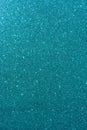 Background with sparkles. Backdrop with glitter. Shiny textured surface. Vertical image. Dark cyan