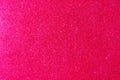 Background with sparkles. Backdrop with glitter. Shiny textured surface. Vivid pink