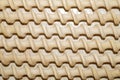 Background of spiral wooden curlers stacked in straight rows