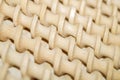 Background of spiral wooden curlers stacked in straight rows