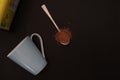 Spoon of cocoa powder and a cup. Royalty Free Stock Photo