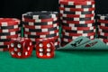 On the background of stacks of chips to play in the casino, two folded cards to view the denomination on the green table, next to