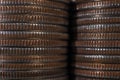 Background from stacks and edges of US coins of 25 cents in circulation. Wall of American quarters close up. Dark backdrop or