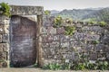 Background with stone fence and old rusty door Royalty Free Stock Photo