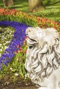 Background stone lion on a background of flowers in Gulhane Park in Istanbul Royalty Free Stock Photo