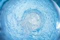 Background with a stream of blue clear liquid, soft focus Royalty Free Stock Photo