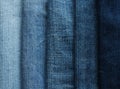 Background from strips of fabric of blue jeans of different shad
