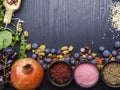 Background of super foods as blueberry, goji, raspberry and strawberry powders, pomegranate, grape, beans, health and clean eating